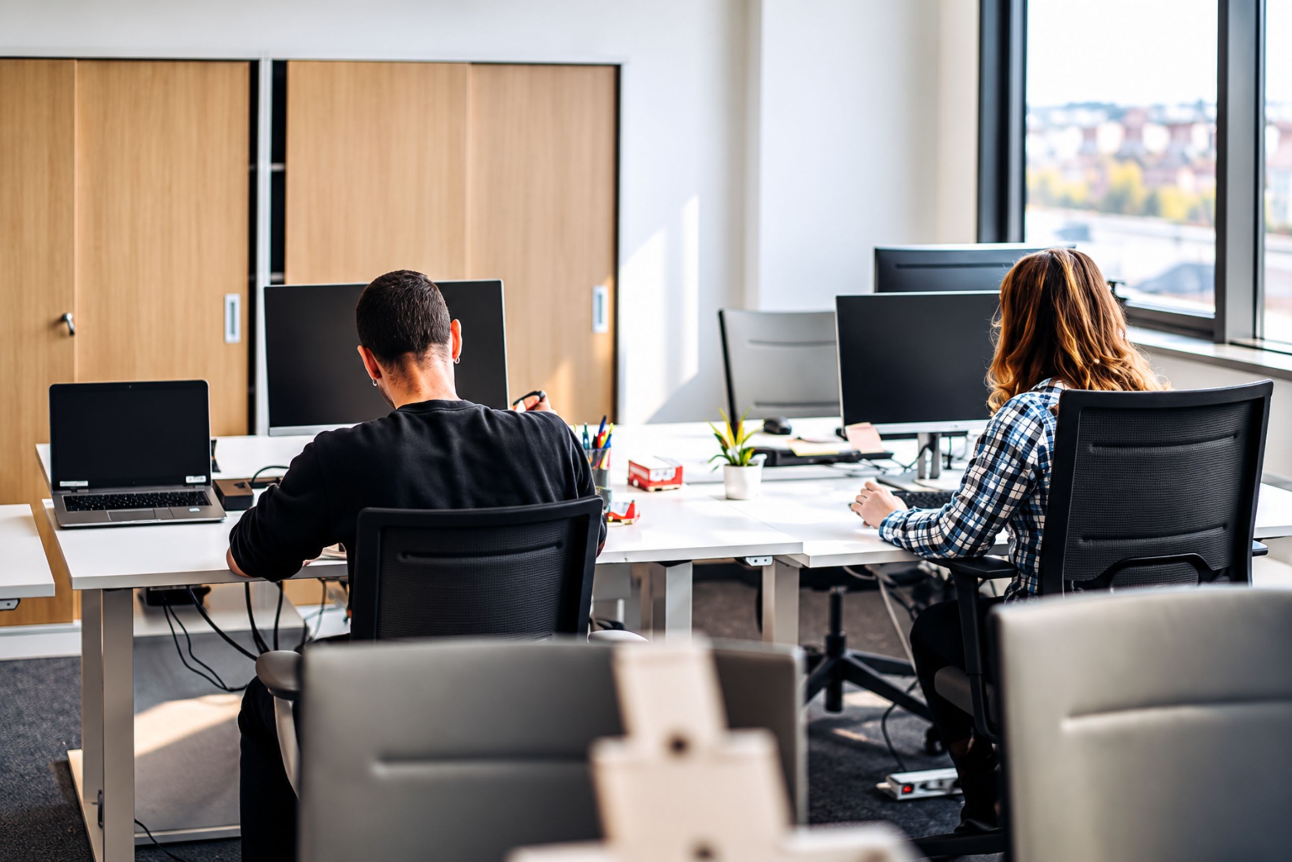Modern Johannesburg office with underused workstations and employees working